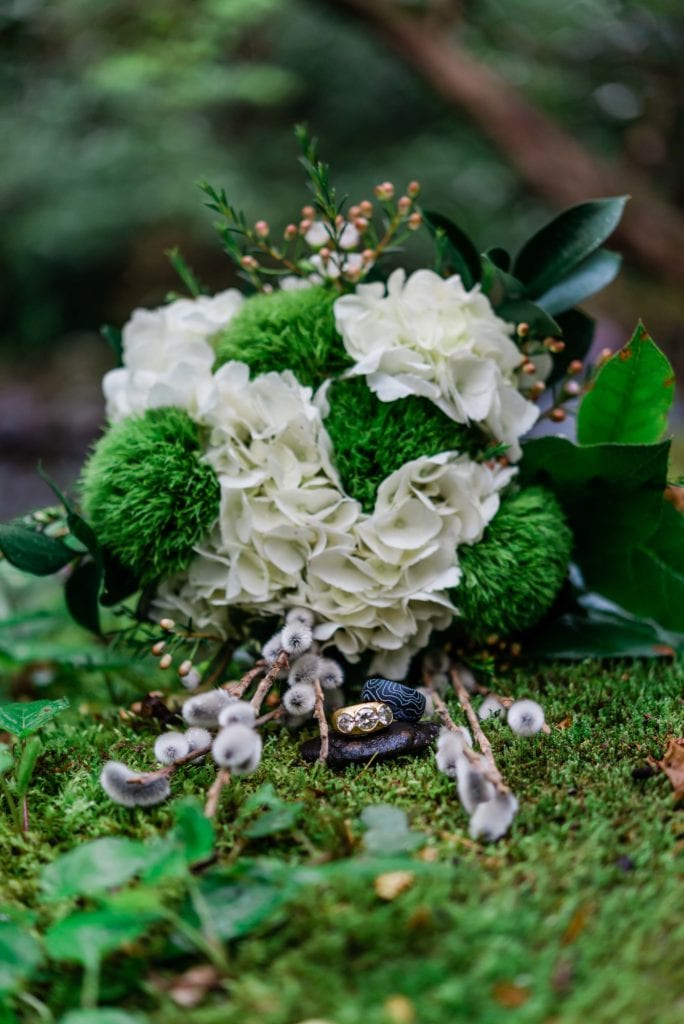 Moss details with the rings and the bouqetduring an adventure elopement