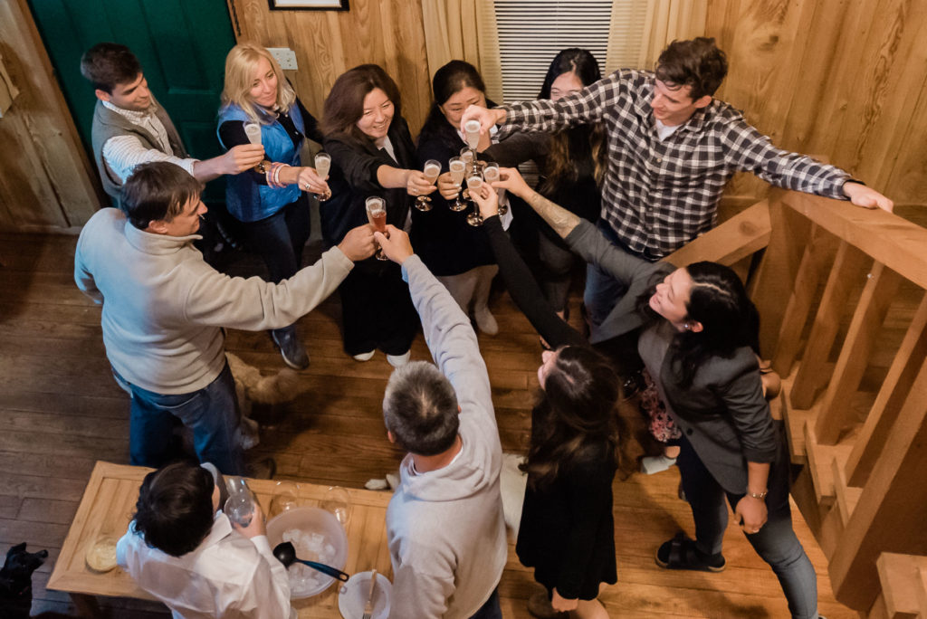 a family toasts the couple while celebrating their elopement