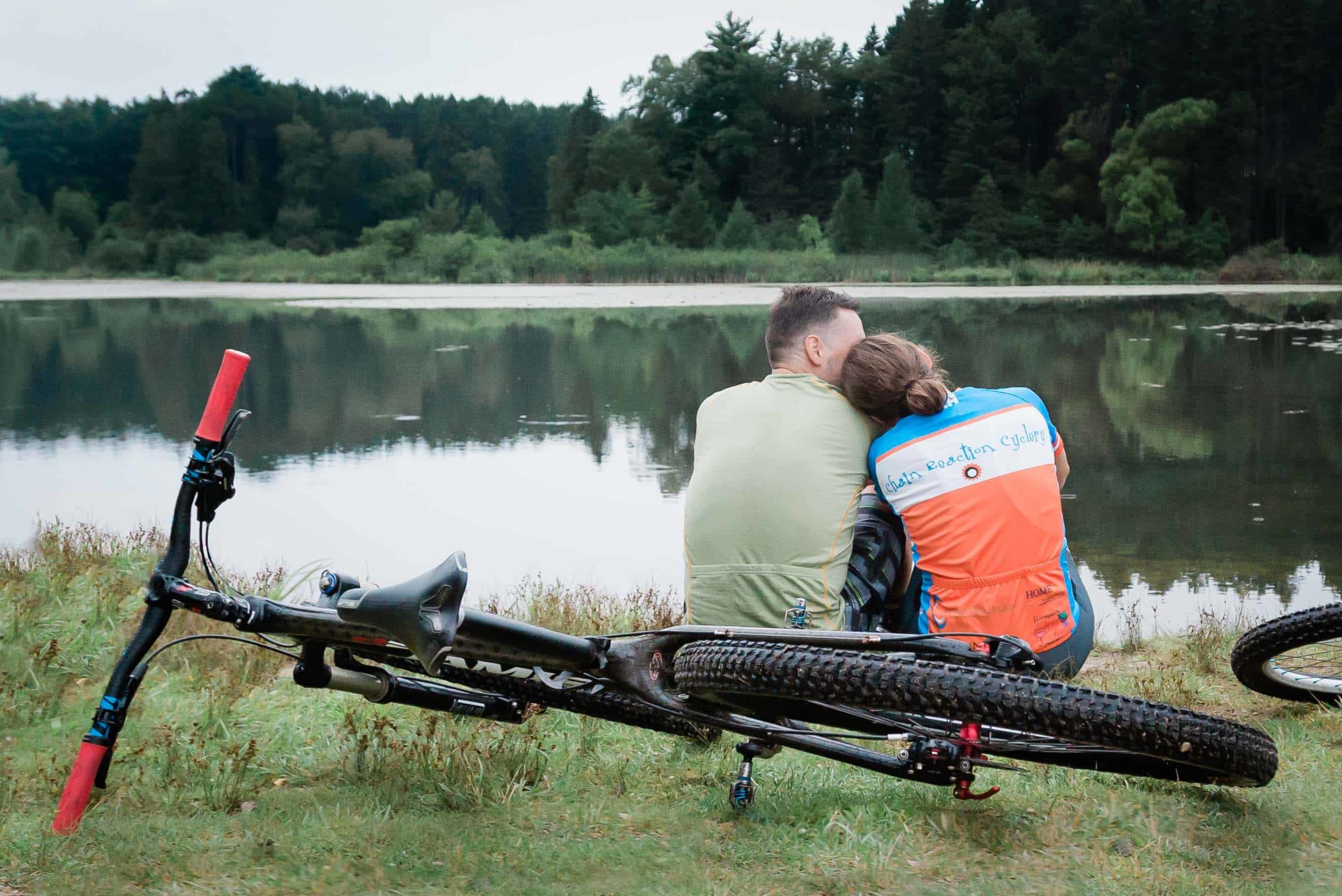 A couple rests during a Tennessee Mountain Bike adventure session with an elopement photographer