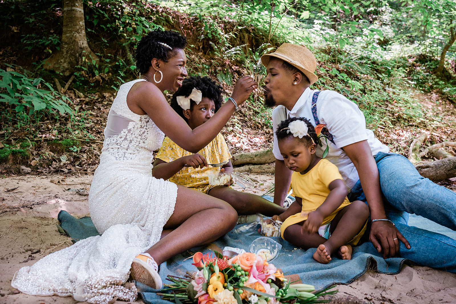 couple shares a picnic with their kids at their adventure elopement
