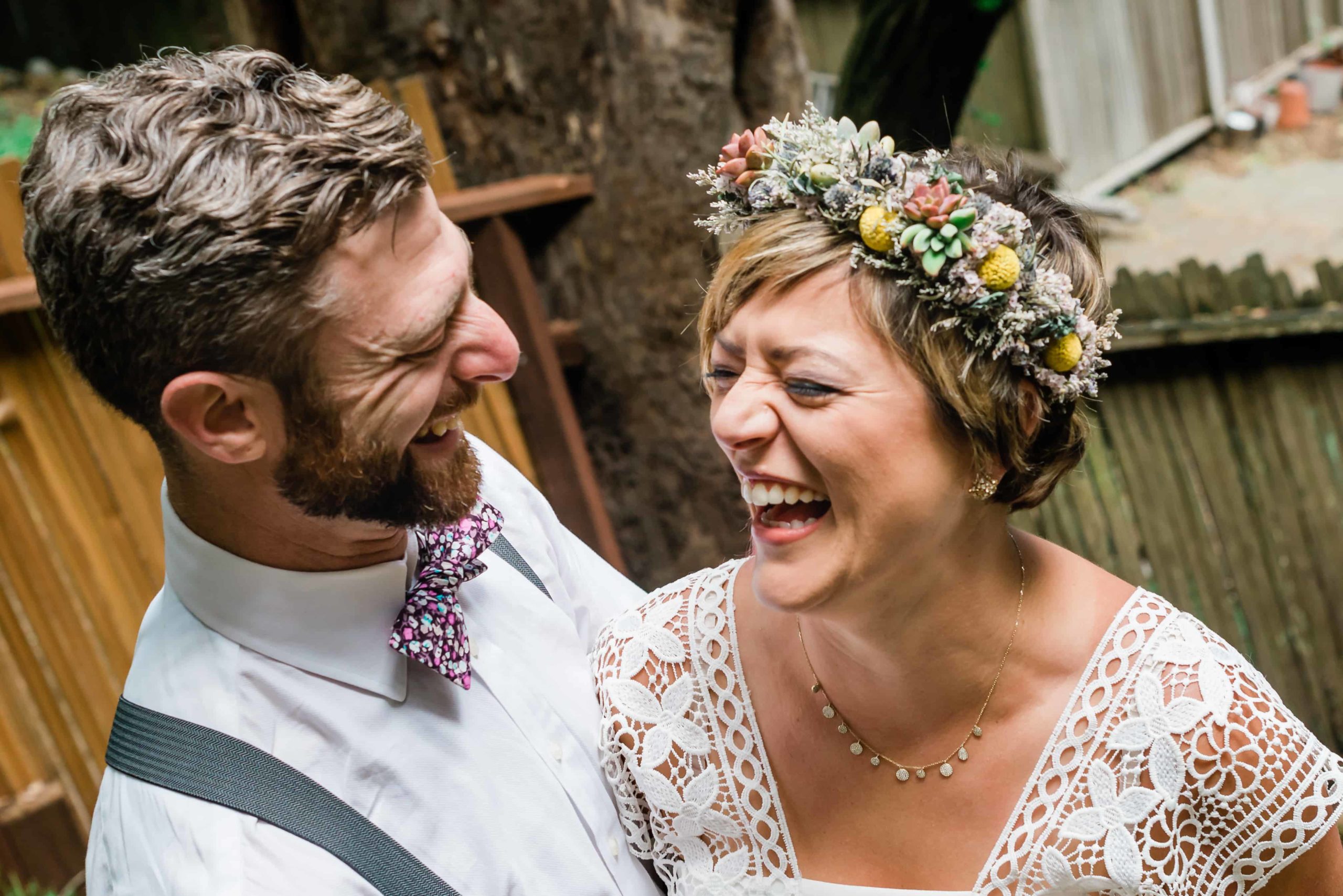 Couple shares a laugh at their elopement; remember, how to tell family you're eloping is totally up to you.