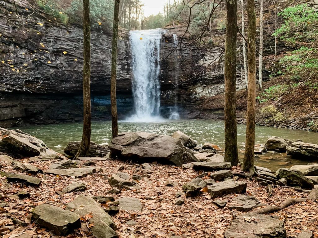 This picture is taken in Cloudland Canyon. It is a picture of a waterfall with some trees and rocks in front of it. Cloudland Canyon is a great spot for an adventure elopement.