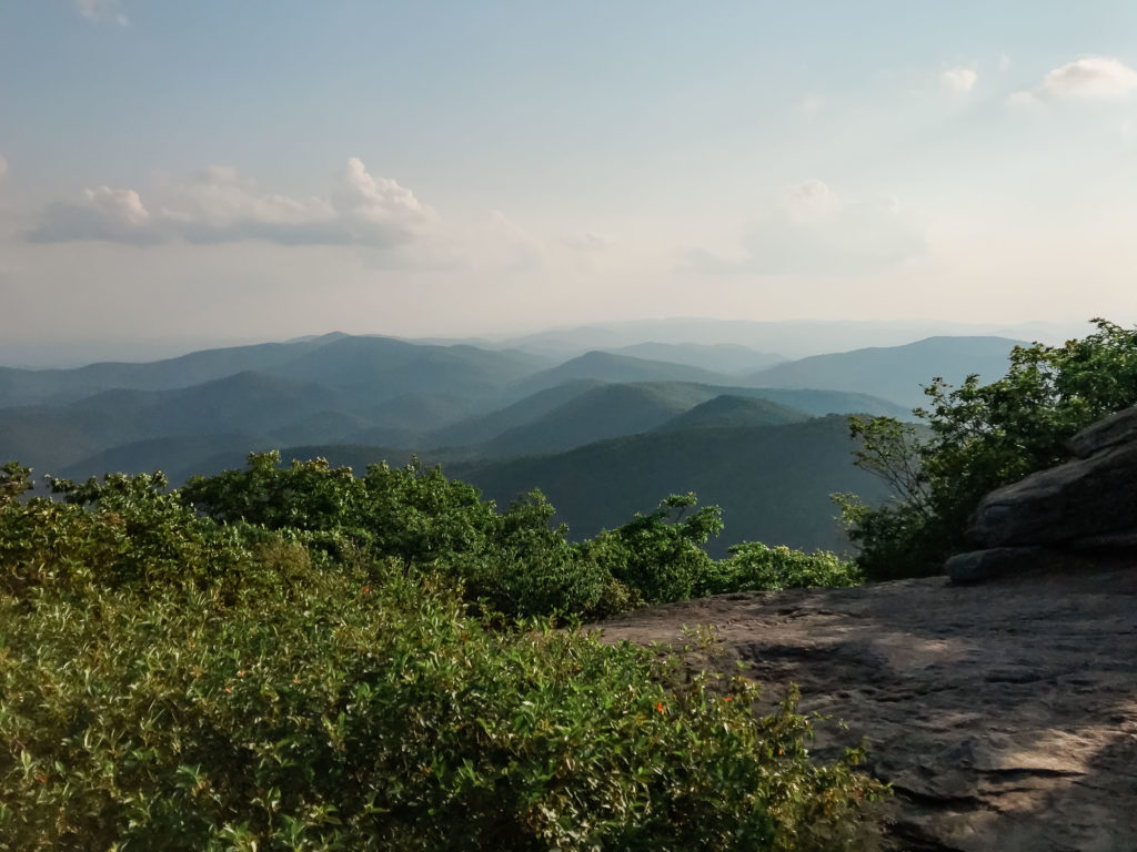 This image is of a summit on the Appalachian Trail. You can see the rolling mountains. 