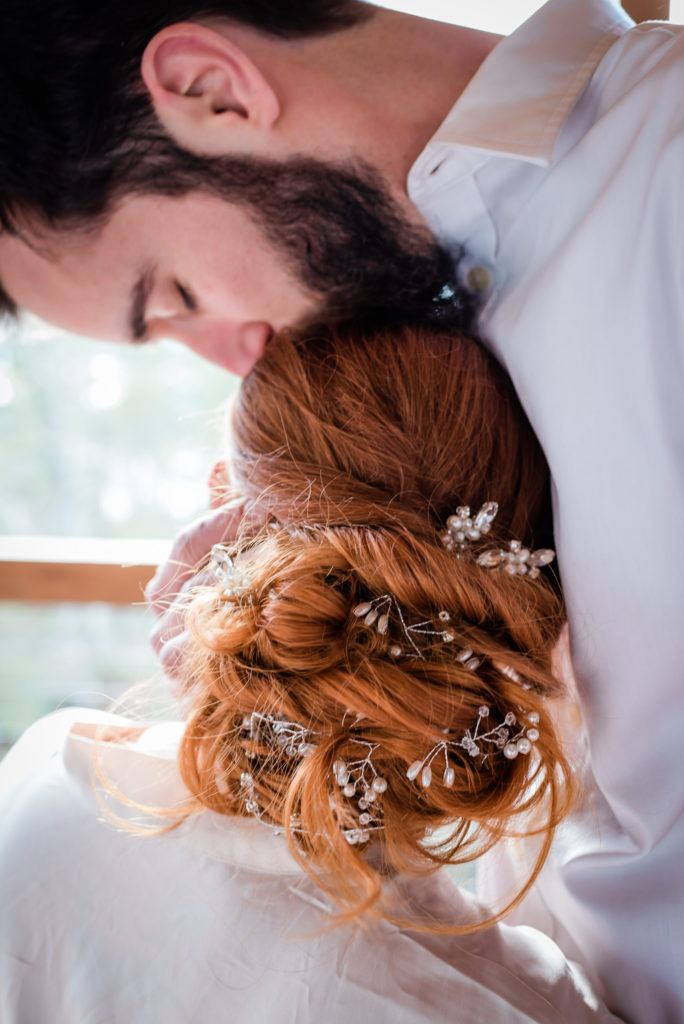 In this picture there is a couple sharing an intimate moment before their wedding. This couple decided during their wedding timeline they would share a lot of special moments.