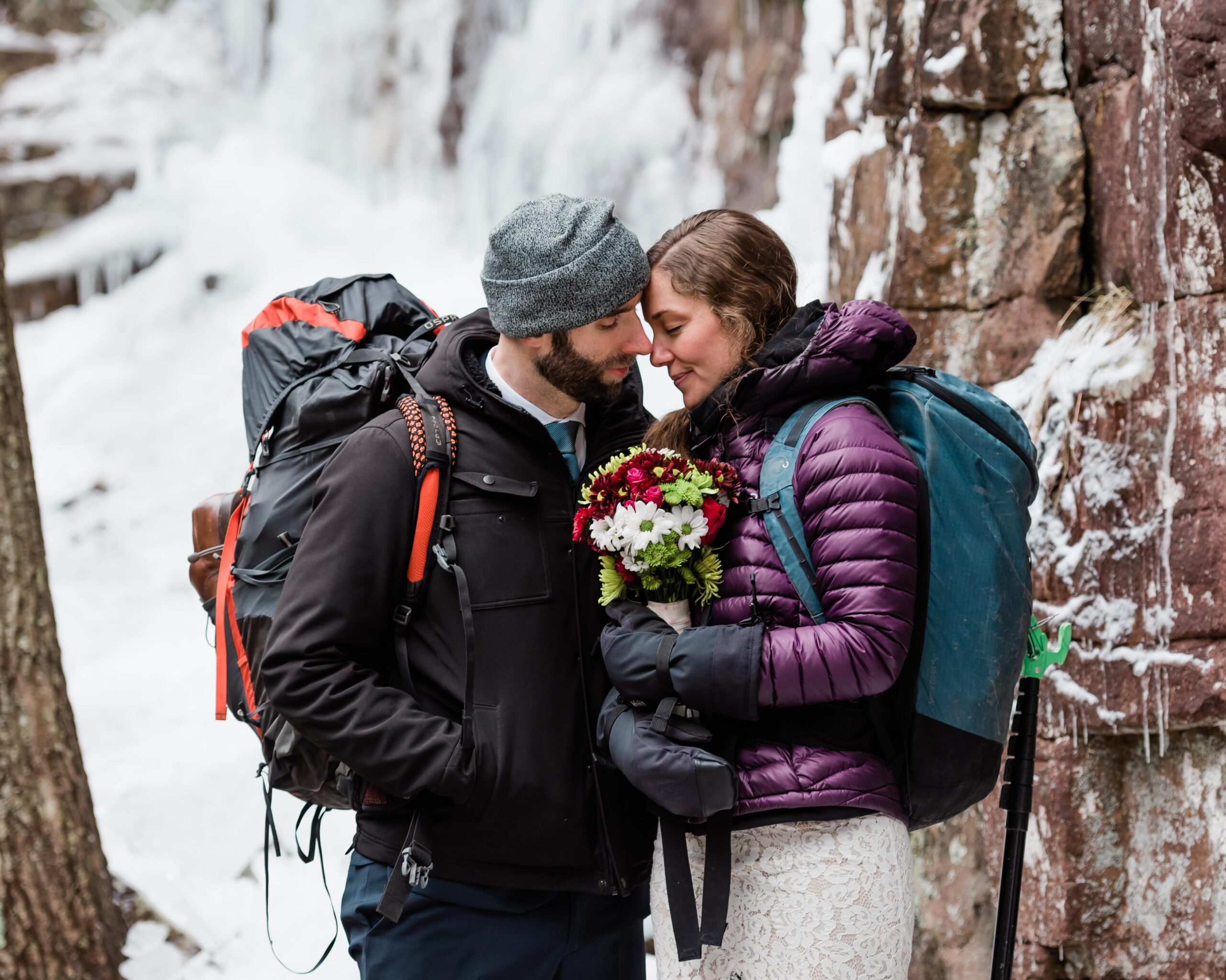 This is a Chattanooga elopement in winter. This picture is the bride and groom bundled up in the snowy forest.